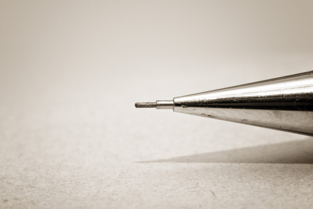 Tip of sharp mechanical pencil on paper